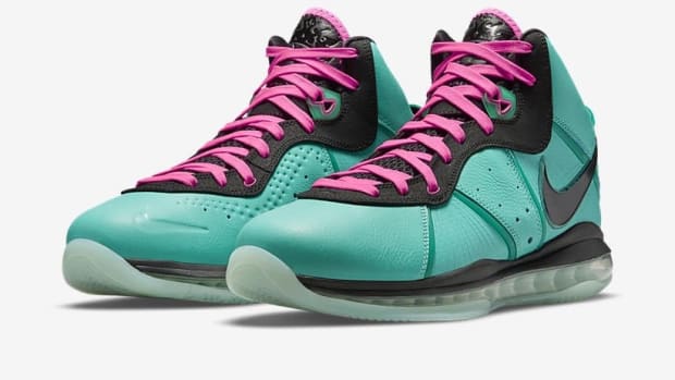 Side view of LeBron James' teal and black Nike sneakers.